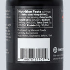 Nutrition facts label and barcode on a black bottle label