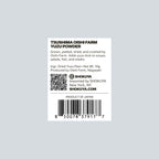 A white rectangular product label for Oishi Farm Yuzu Powder, featuring black text, a QR code, and a barcode on a light gray background. The label includes Shokuya branding and product details.