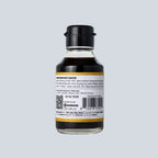 Bottle of soy sauce with a label on a gray background