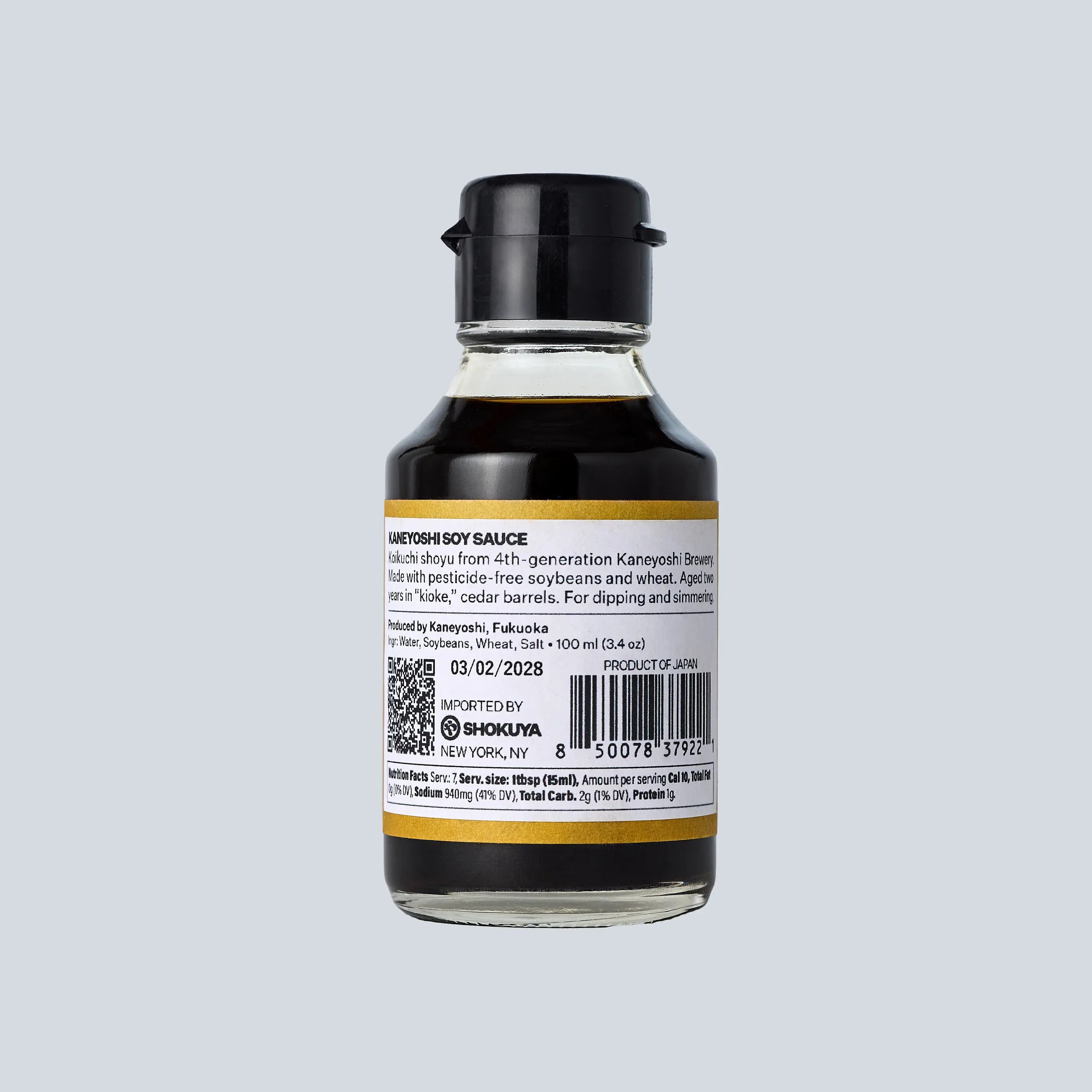 Bottle of soy sauce with a label on a gray background