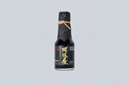 Bottle of Matsuai 10-Year-Aged Soy Sauce with a textured label on a light gray background. 