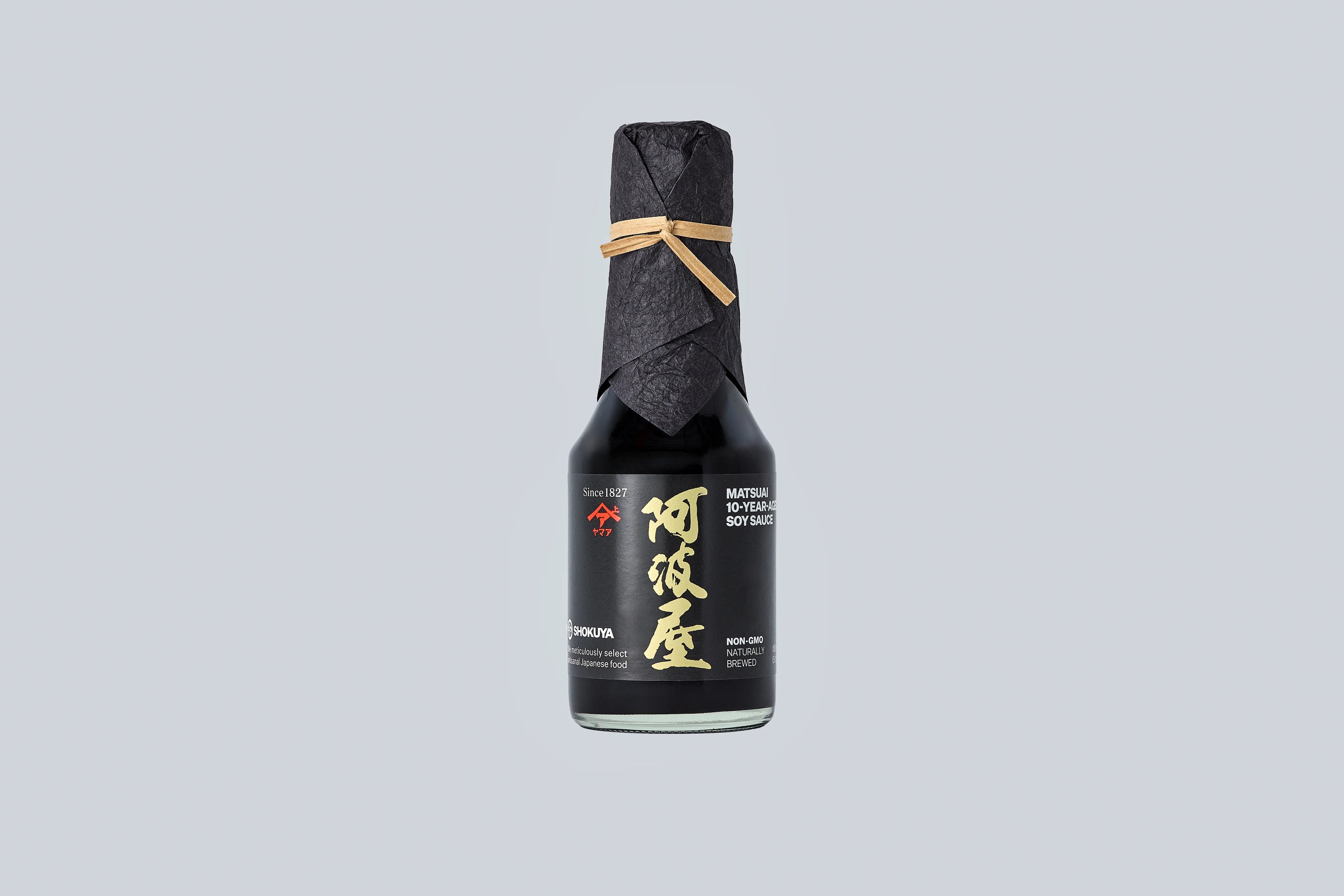 Bottle of Matsuai 10-Year-Aged Soy Sauce with a textured label on a light gray background. 