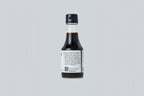 Bottle of soy sauce on a light gray background
