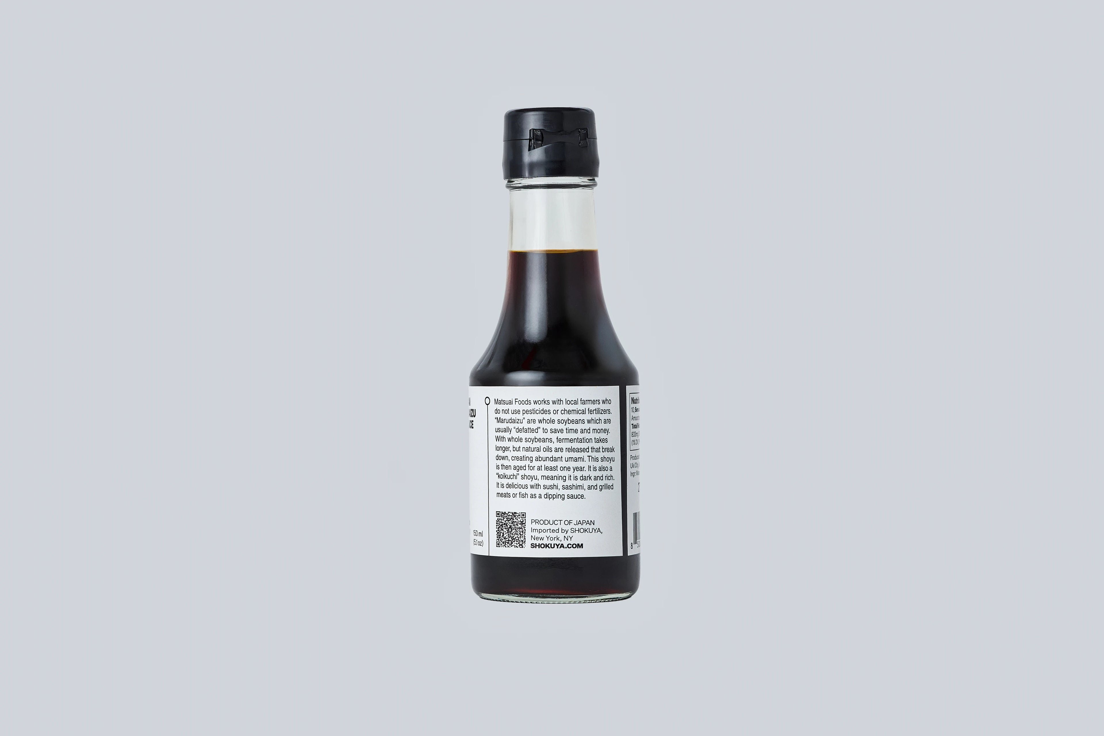 Bottle of soy sauce on a light gray background