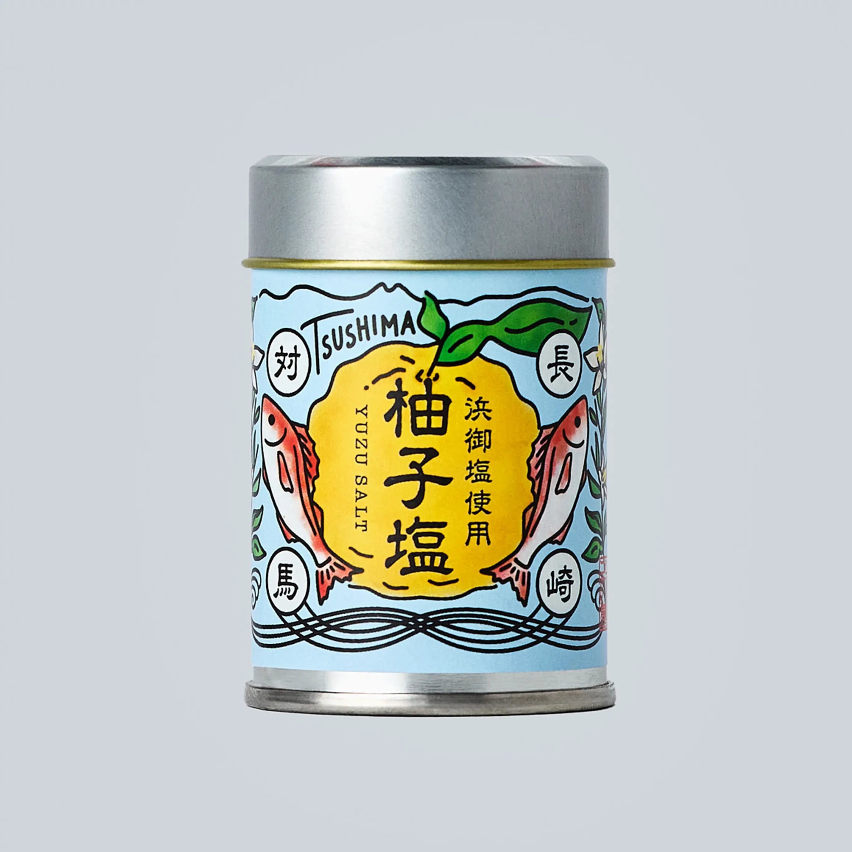 Small metal canister of Japanese yuzu salt from Oishi Farm centered on a light gray background, with a blue illustrated label showing yuzu fruit, fish, and Japanese text.